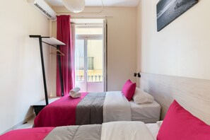 A hotel room with two beds, a balcony, and a view of the sea. - Red Nest Hostel (Valencia)