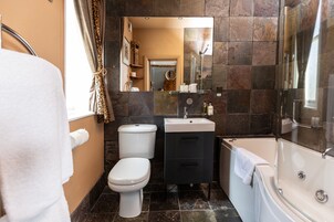 A bathroom with a toilet, sink, and bathtub.