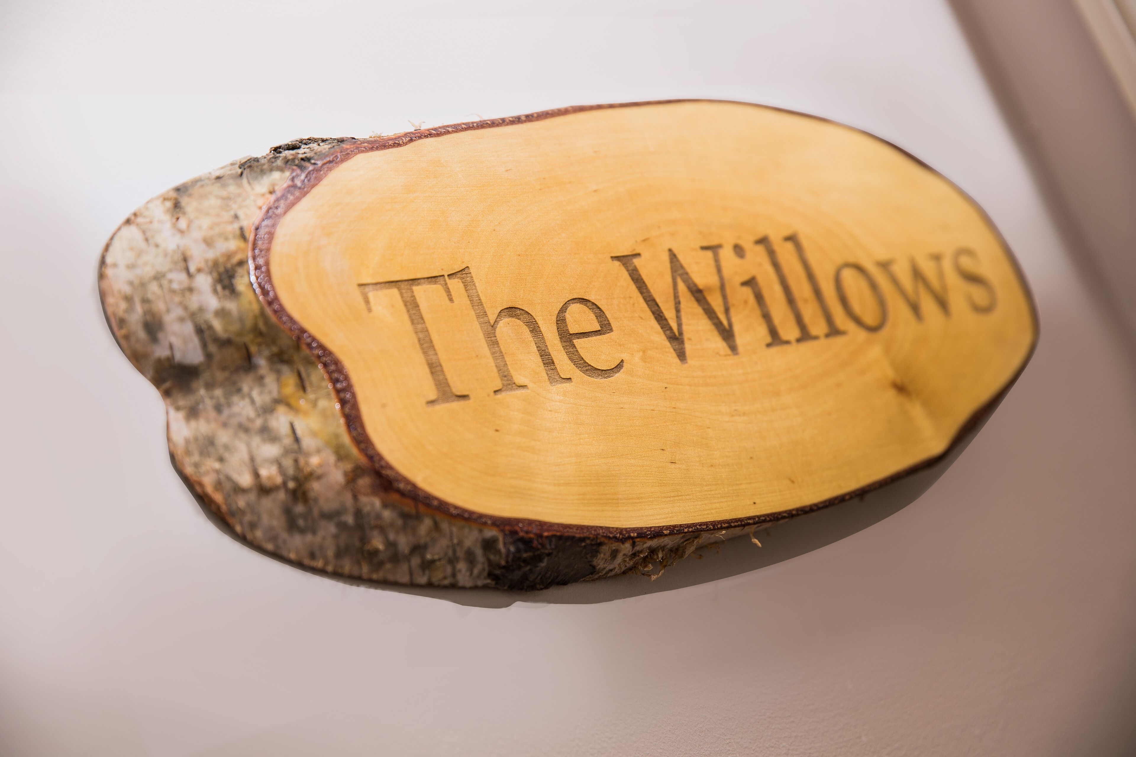 Una targa di legno con l'iscrizione 'The Willows'.