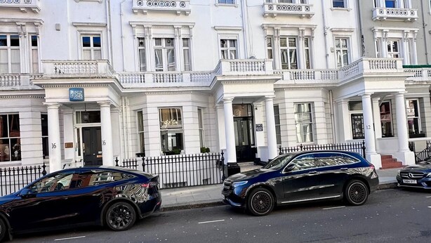 A row of white, classical-style buildings with multiple windows and balconies. - Acacia Hotel (London)