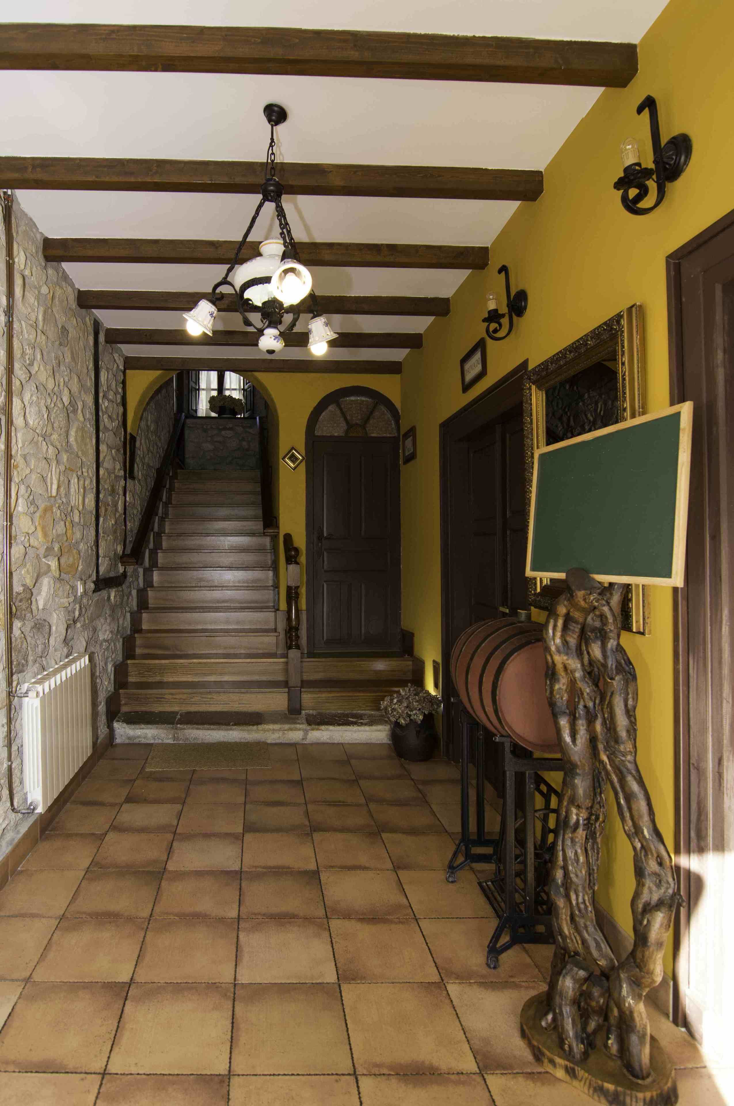 A staircase with wooden steps and a stone wall on one side.