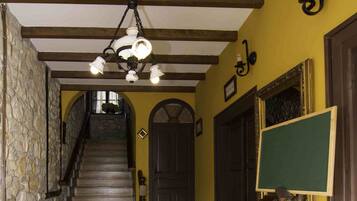 A staircase with wooden steps and a stone wall on one side.