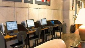 Een computerruimte met meerdere werkplekken, elk voorzien van een monitor en toetsenbord.