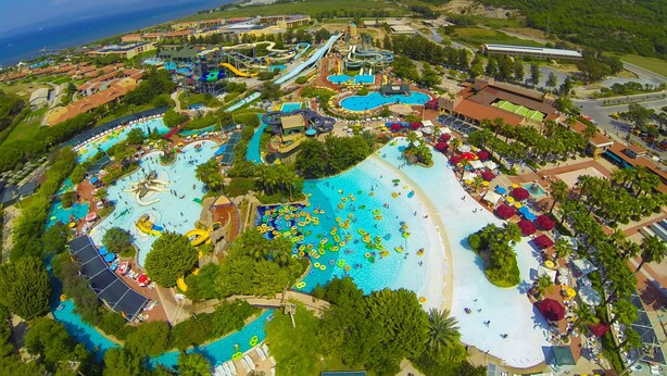 A large water park with multiple pools, slides, and a beach area. - Aqua Fantasy Aquapark Hotel & Spa - All Inclusive (Selçuk)