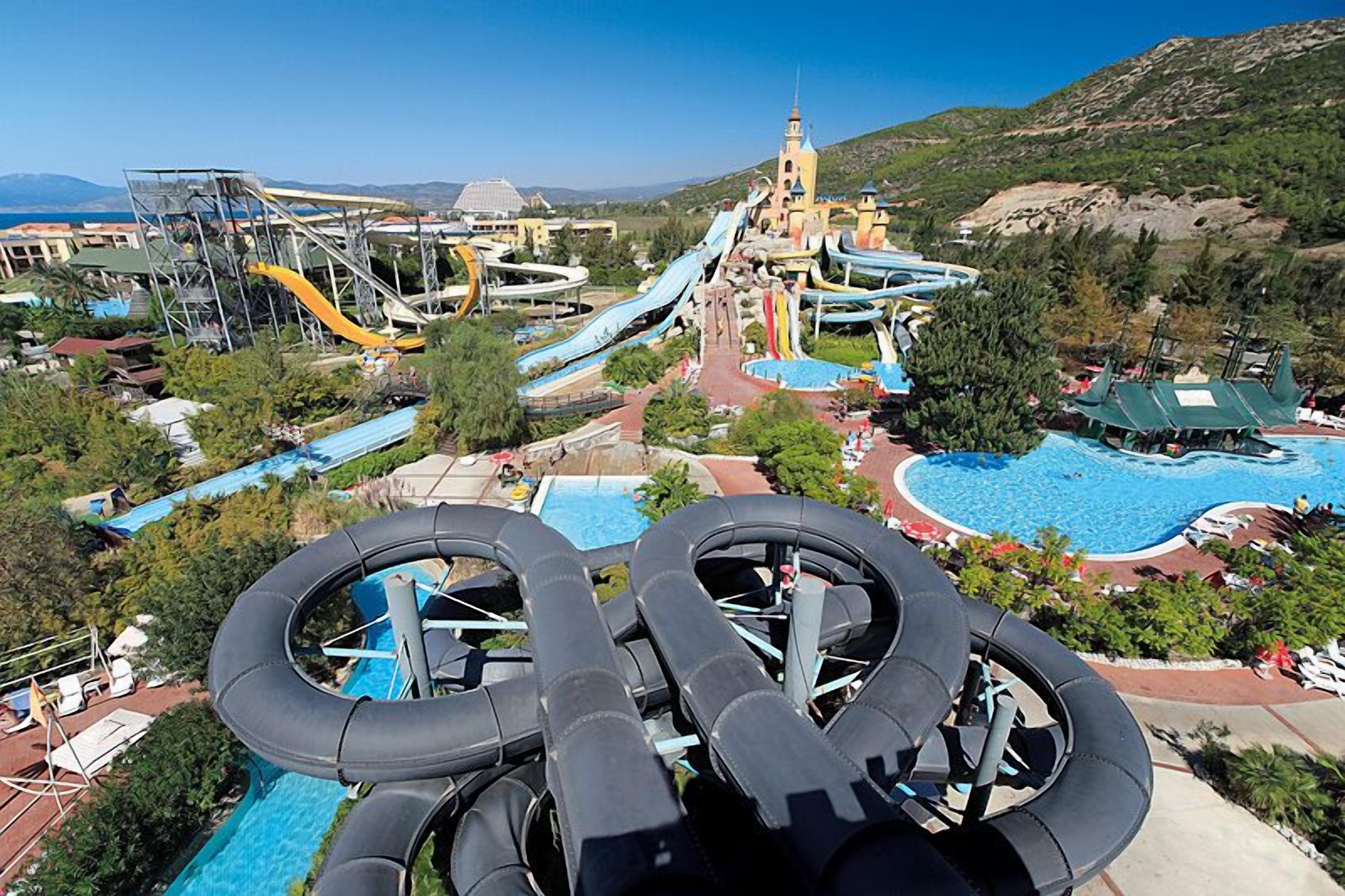 A water park with multiple slides and a pool area.