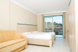 A hotel room with a bed, a sofa, a window with a view of the outdoors, and a balcony. - Aparthotel Siesta Beach Bodrum (Bodrum)