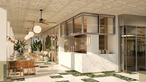 A spacious hotel lobby with a marble floor, a reception desk, and a dining area with chairs and tables. - Selomar (Benidorm)