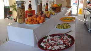 A buffet table with various food items including fruits, salads, and a large bowl of pasta salad. - Hotel Belleville (Nessebar)
