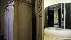 A room with a classic wooden wardrobe and a modern shower enclosure. - Hotel Sofia (Catania)