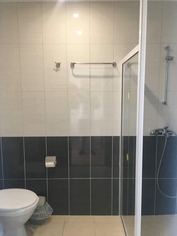 A bathroom with a toilet, a glass shower enclosure, and a towel rack. - Largo (Sunny Beach)