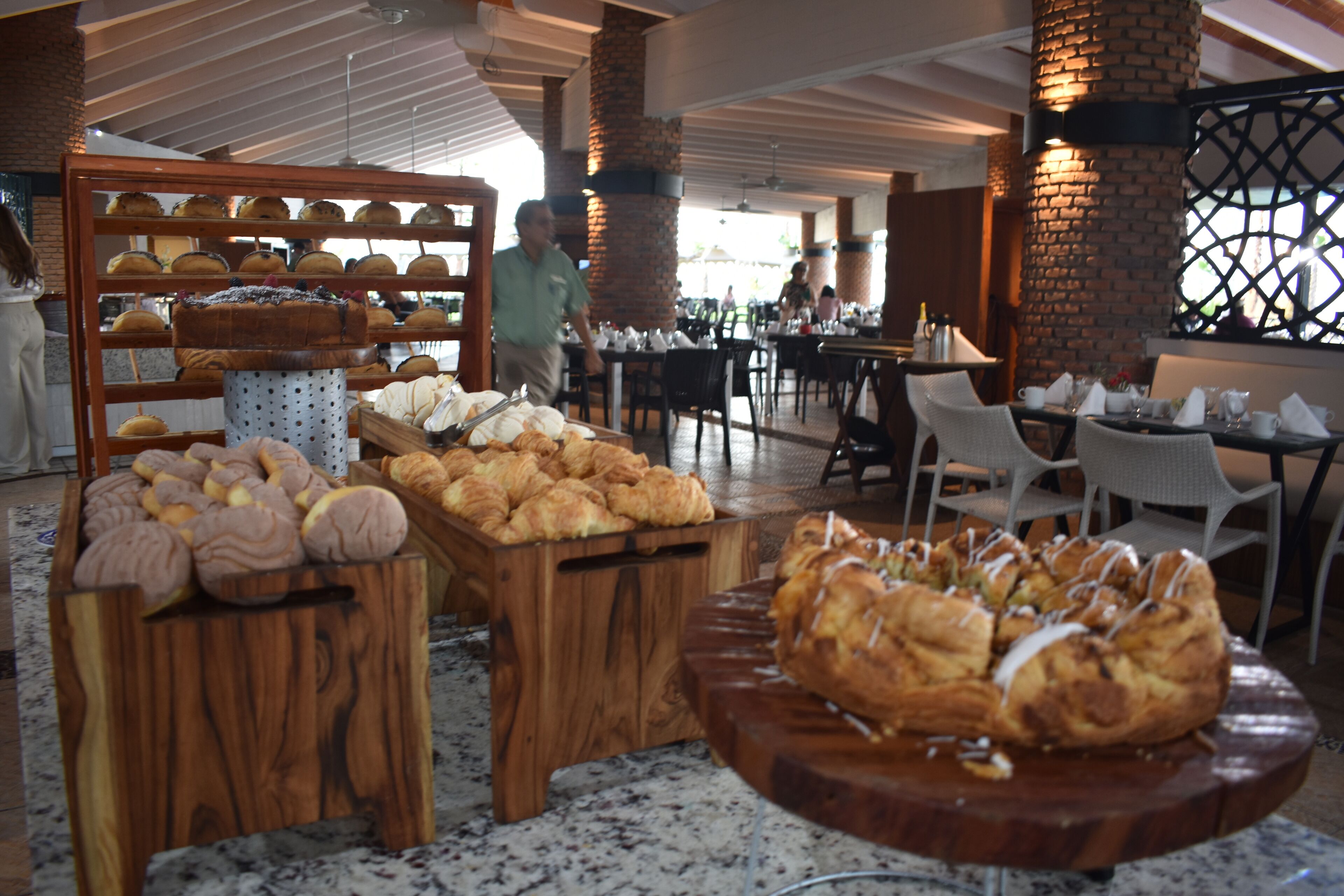 A bakery display with various baked goods in a restaurant setting.