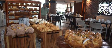 A bakery display with various baked goods in a restaurant setting.