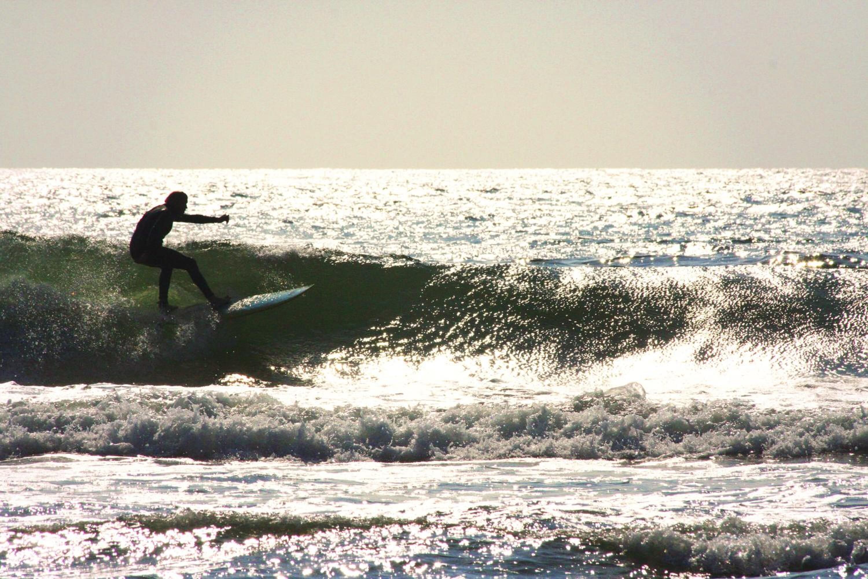 A surfer riding a wave in the ocean.