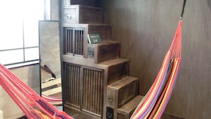 A room with a wooden staircase, a hammock, and a radiator. - Omotenashi LAB - Hostel (Sakura)