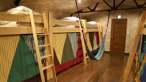 A room with bunk beds, hammocks, and a wooden door. - Omotenashi LAB - Hostel (Sakura)