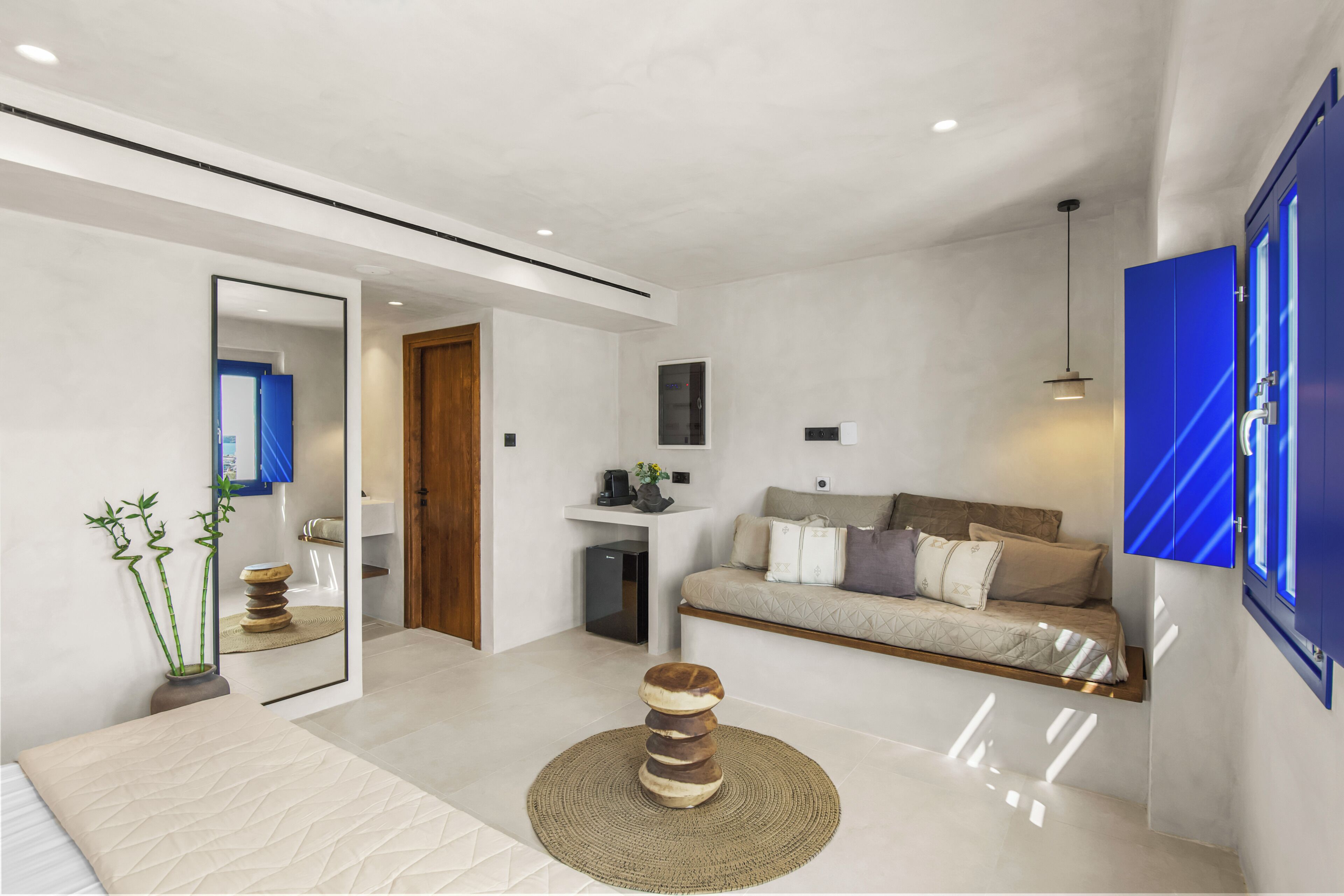 A modern living room with a sofa, coffee table, and a television mounted on the wall.