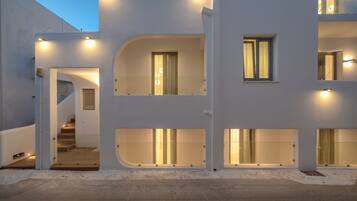 A modern building with multiple balconies and staircases.