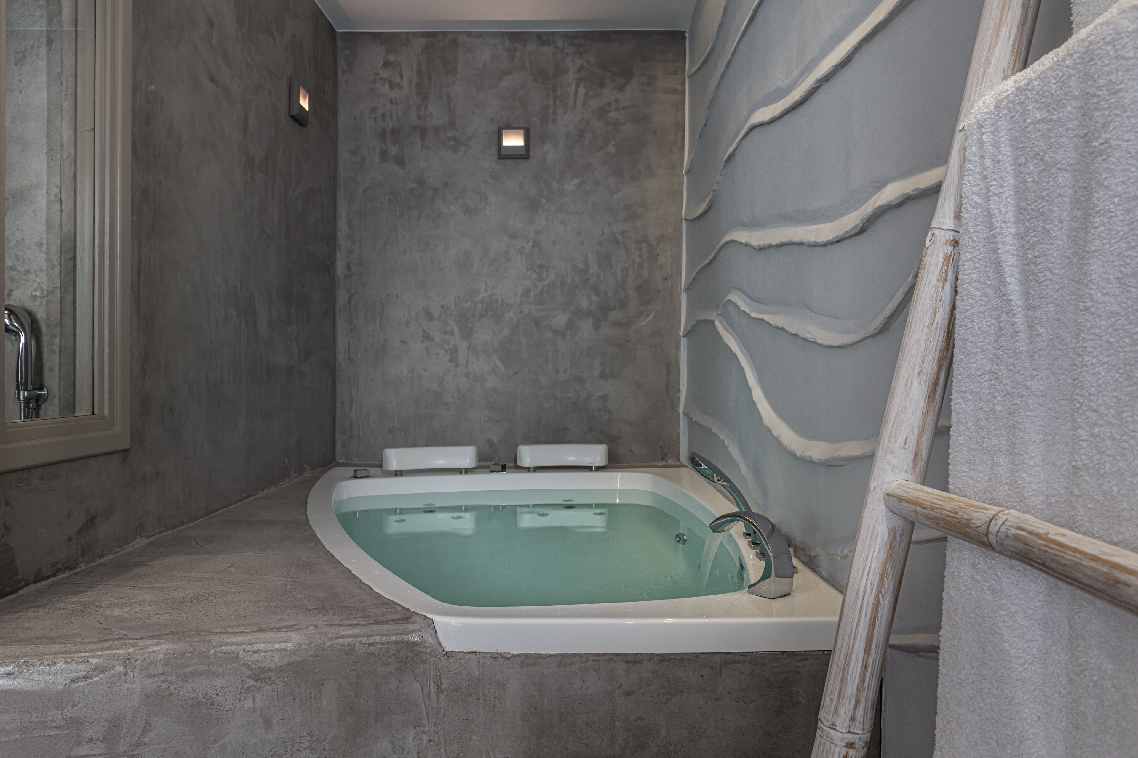 A modern bathroom with a freestanding bathtub, a shower area, and a large mirror.
