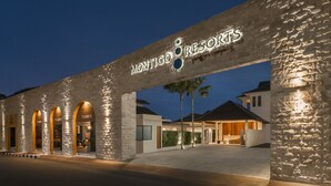A hotel entrance with a stone facade and arched doorways labeled "TAD'S." - Montigo Resorts Seminyak (Keroboken Kelod)