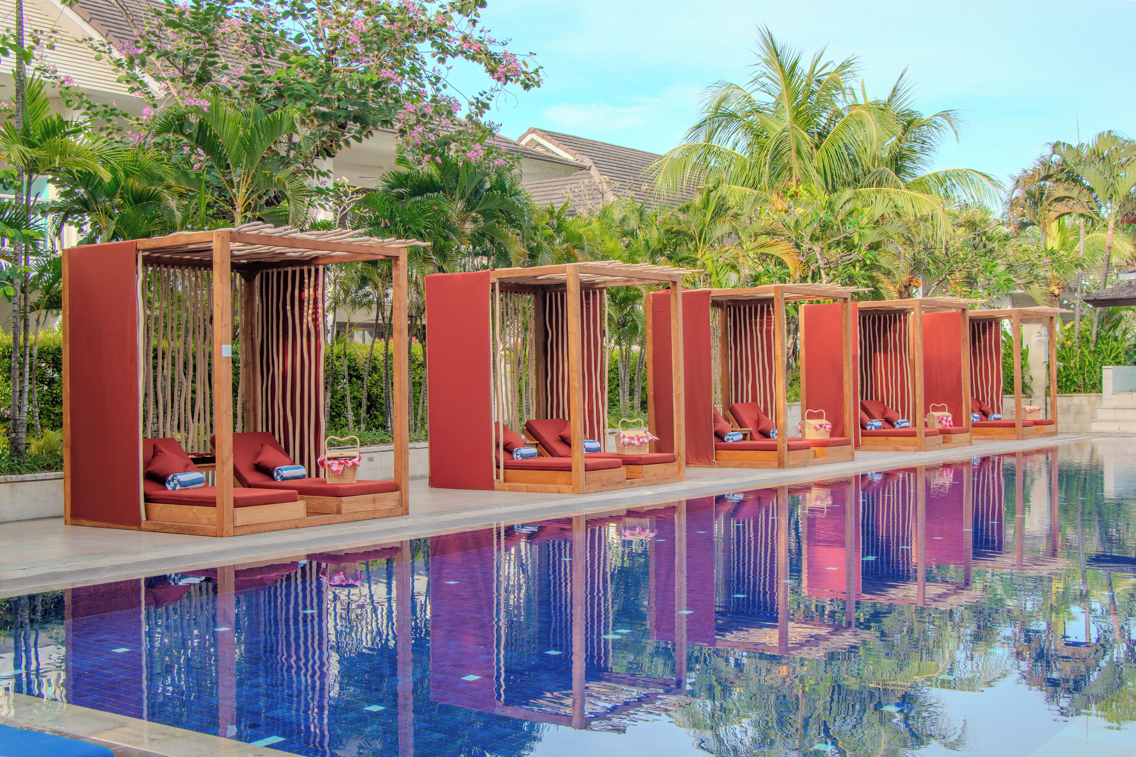 A poolside area with lounge chairs and a pool.
