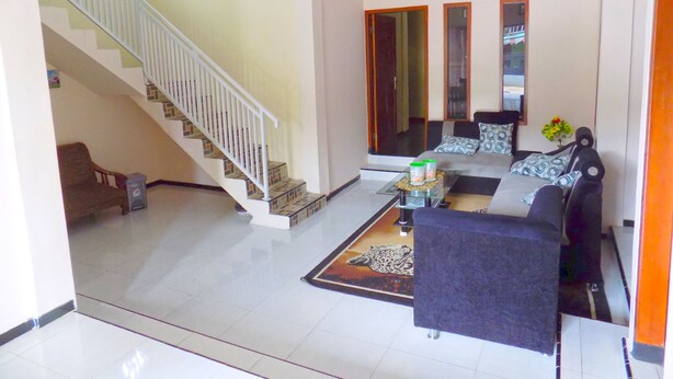 A spacious living room with a staircase, a sofa set, and a coffee table.