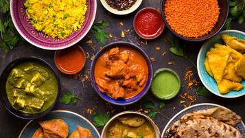 A variety of Indian dishes including rice, lentils, and curries.