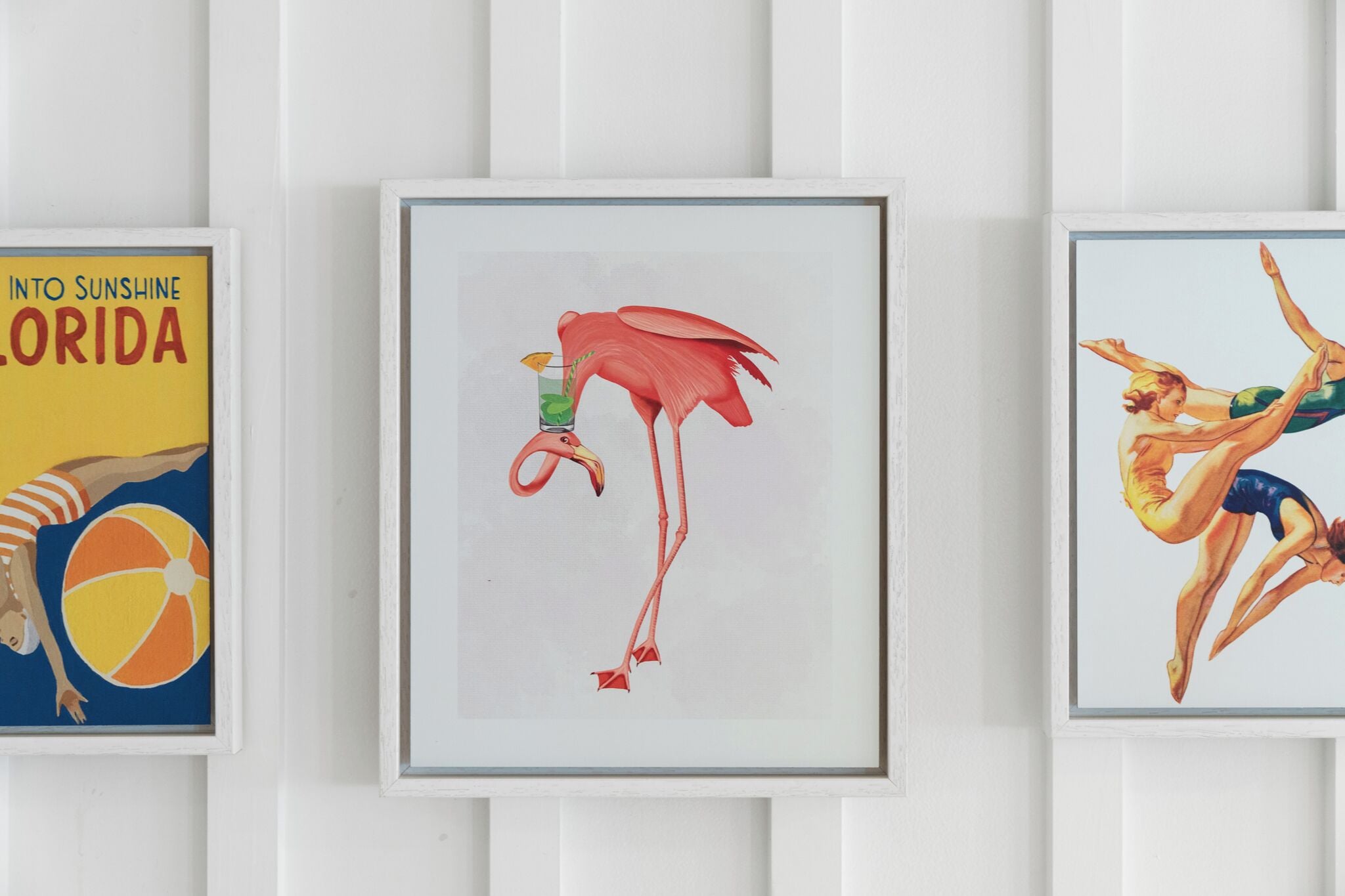 Three framed artworks on a wall.