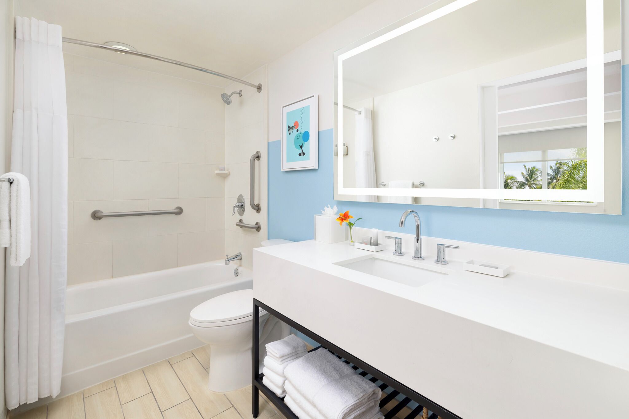 A modern bathroom with a bathtub, toilet, and sink.