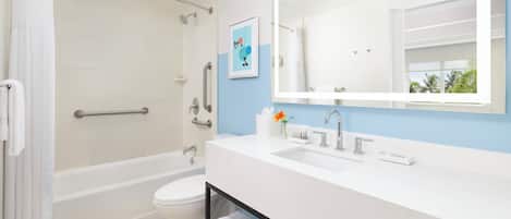 A modern bathroom with a bathtub, toilet, and sink.