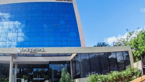 A modern hotel building with a glass facade and a sign reading "CARNAVAL HOTEL". - Carnaval Hotel Casino (Encarnacion)