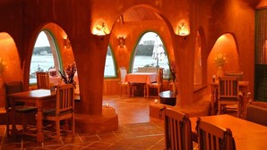 A restaurant with a rustic interior, featuring wooden furniture and arches. - Shima Mediterranean Village (Shima)
