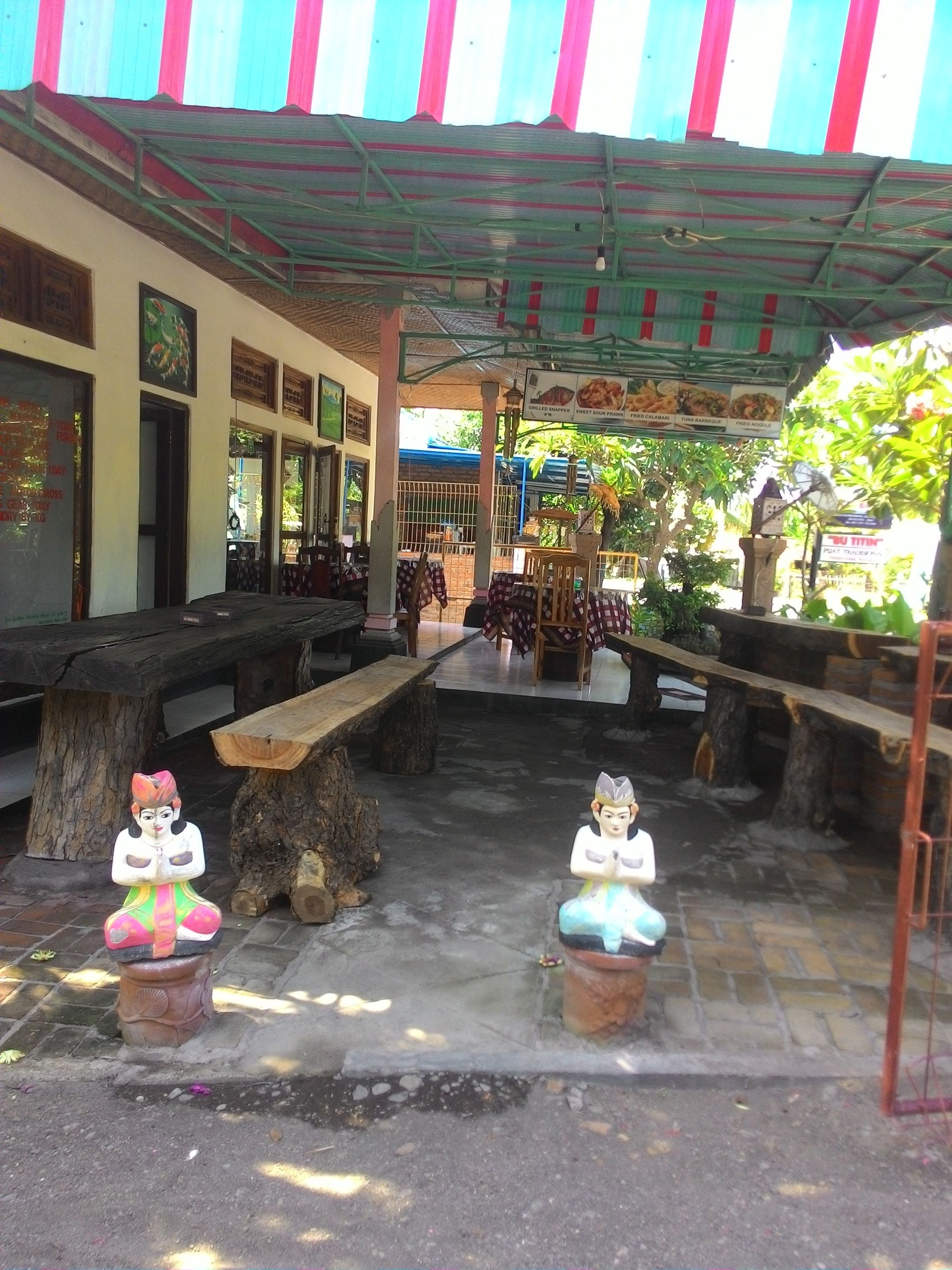 An outdoor seating area with benches and a covered section.