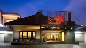 A modern building with a prominent sign reading "Nyland Cipaganti." - Hotel Nyland Cipaganti (Bandung)