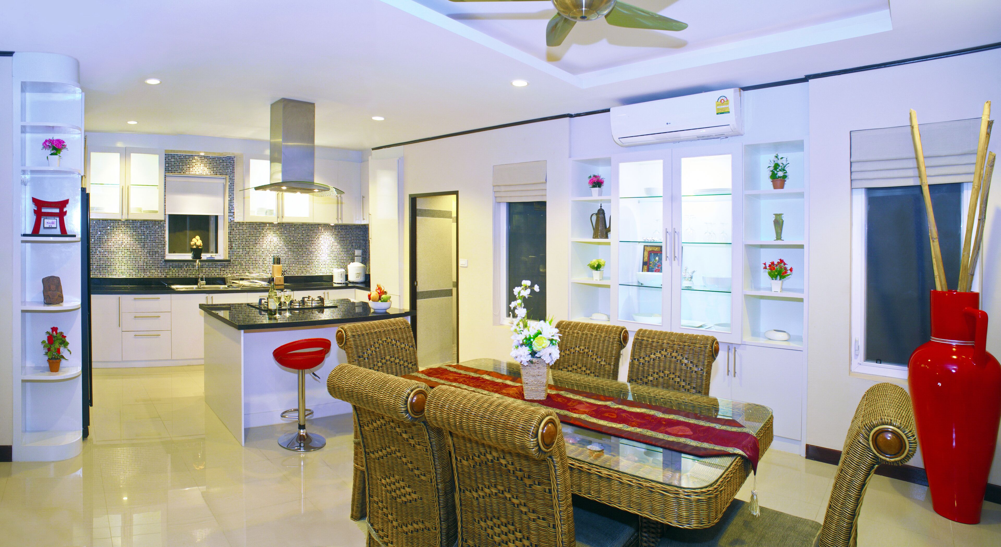 A modern kitchen with white cabinets, a black countertop, and a central island.