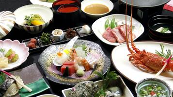 A variety of dishes including seafood, sashimi, and sushi on a table.