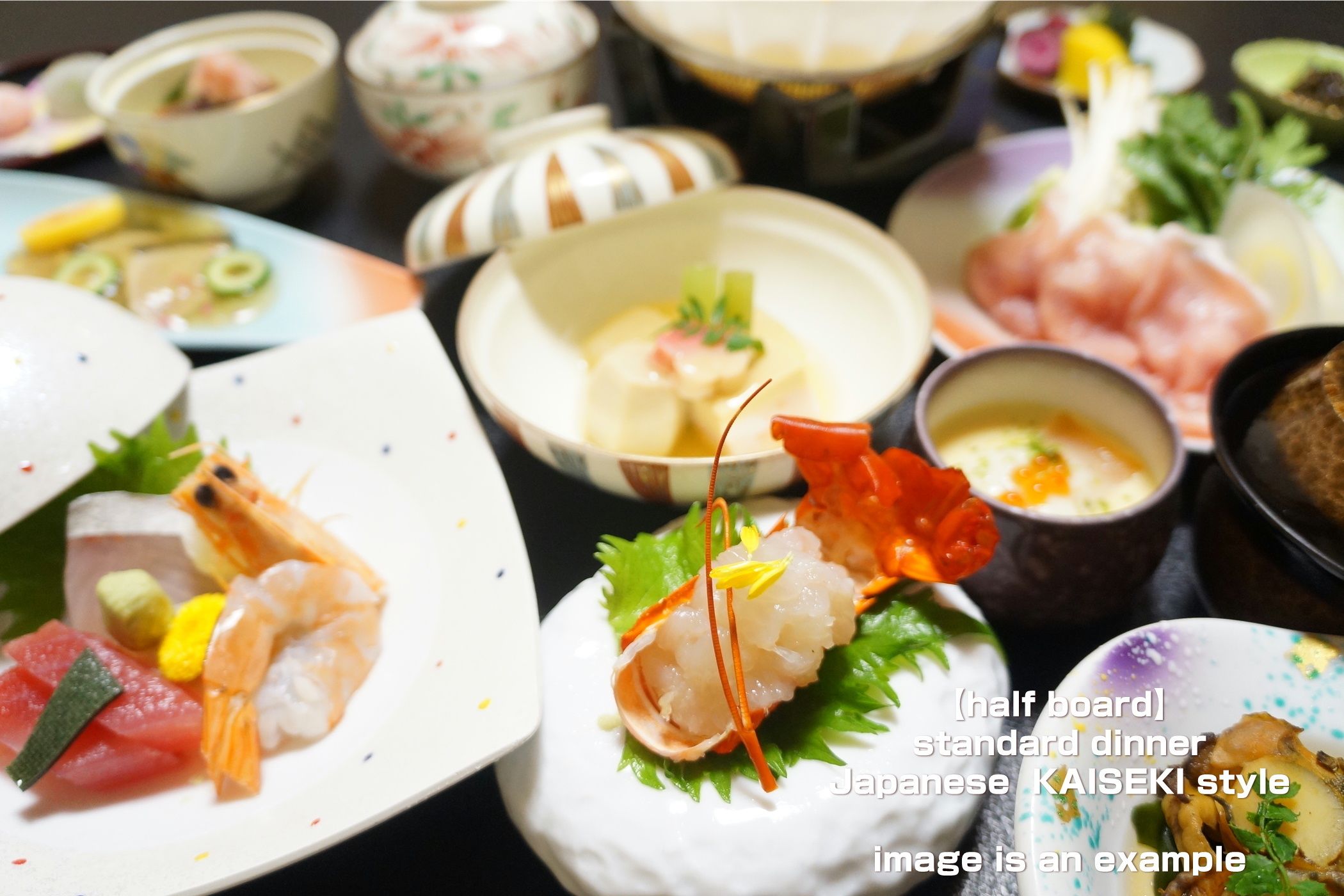 A variety of Japanese Kaiseki style dishes on a half board.