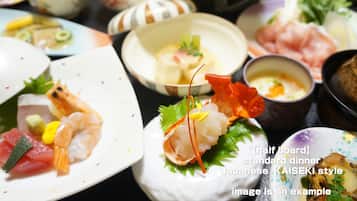 A variety of Japanese Kaiseki style dishes on a half board.