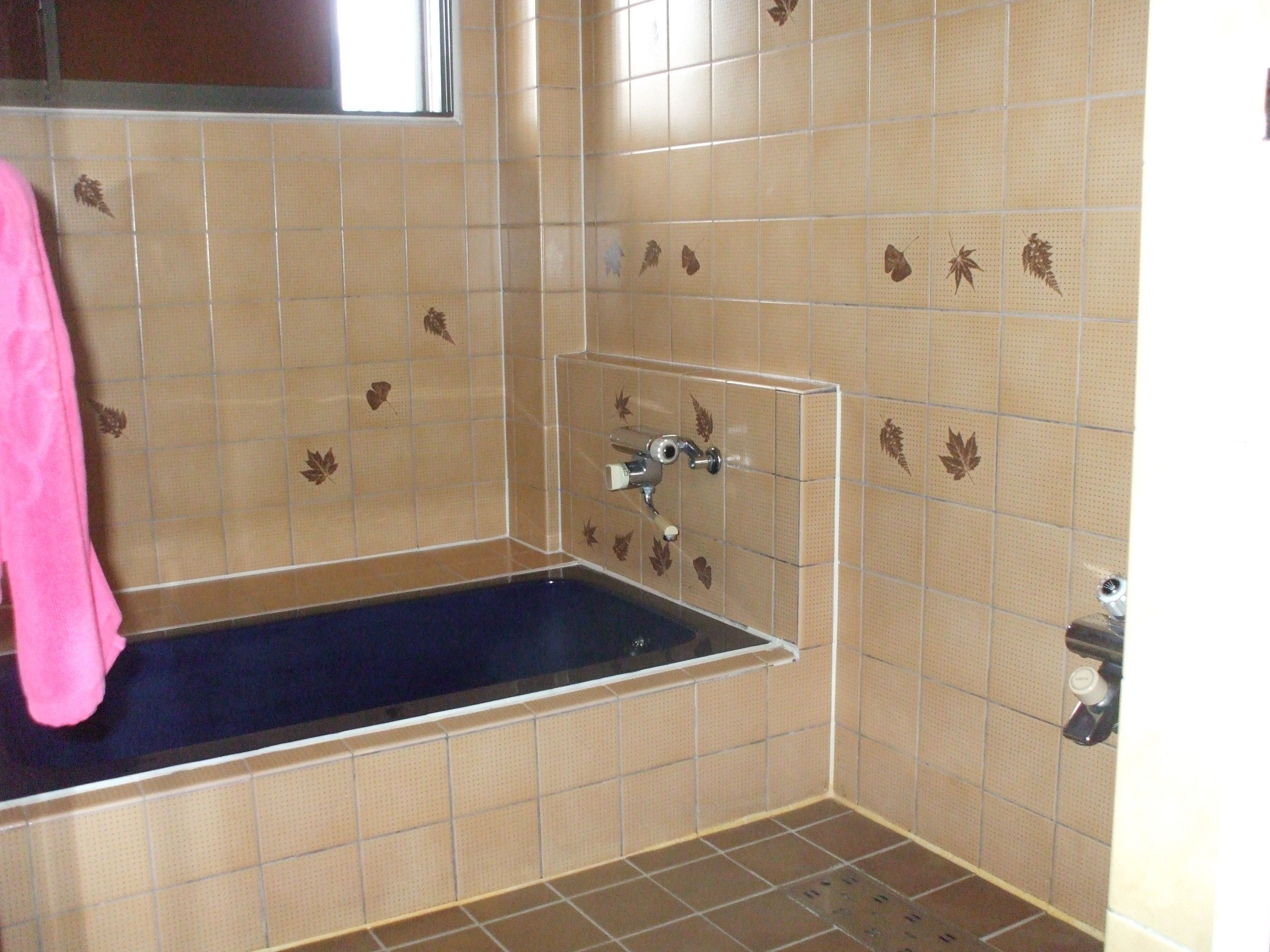 A bathroom with a bathtub, a shower, and a toilet.