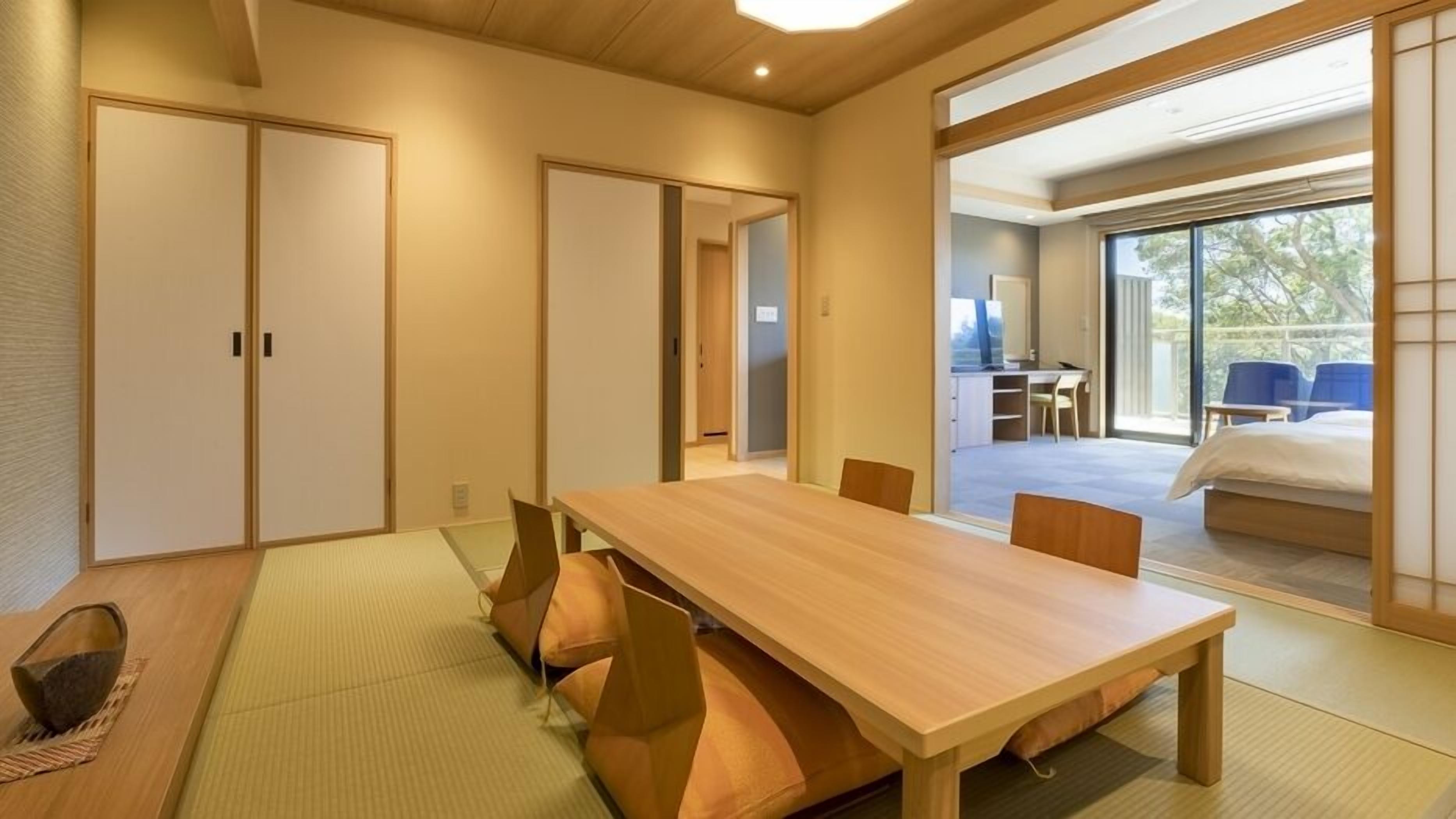 A traditional Japanese-style room with tatami flooring, a wooden table, and sliding doors.