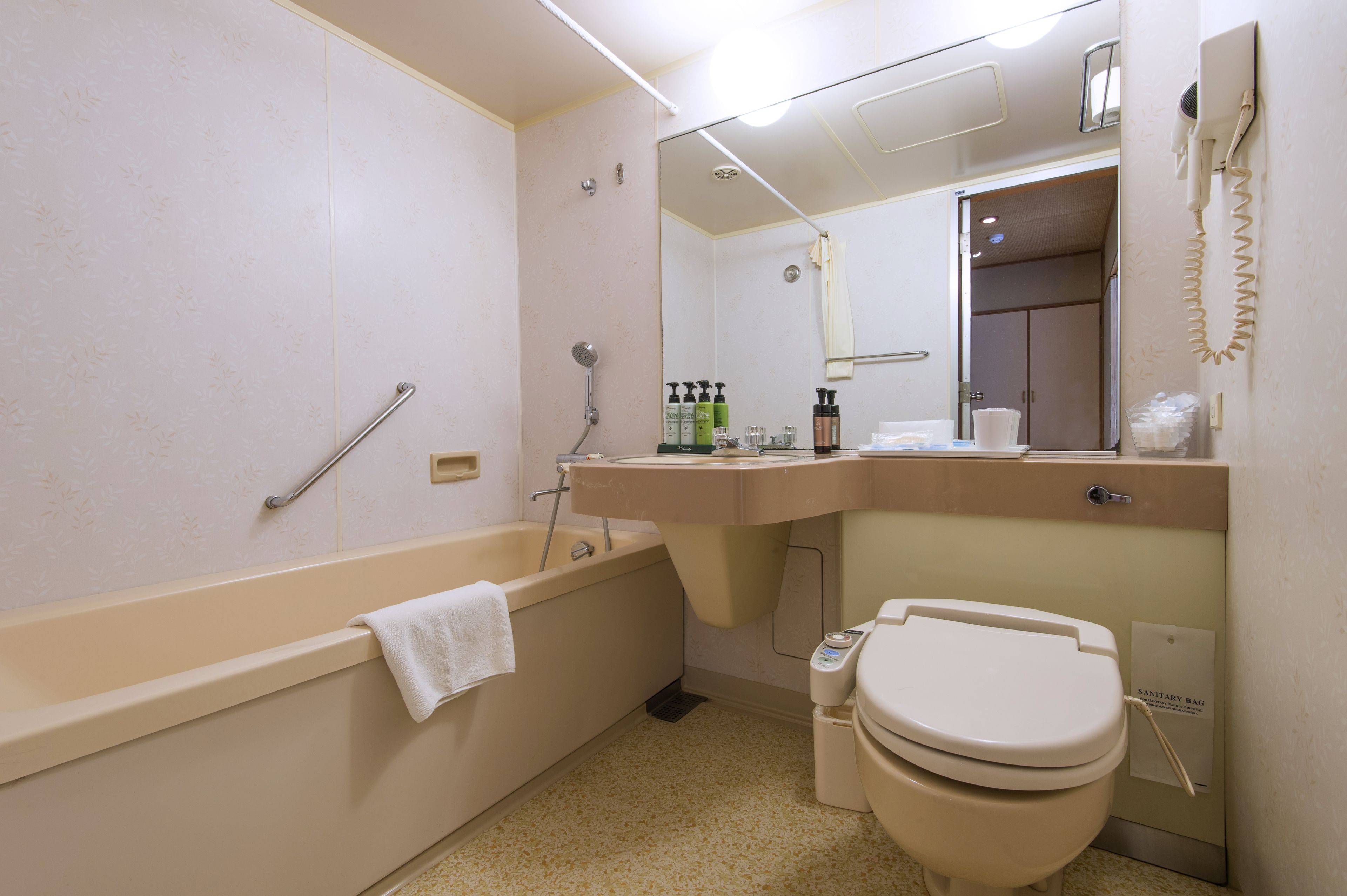 A bathroom with a bathtub, toilet, and sink.
