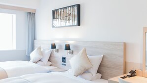 A hotel room with two beds, a large window, and a wall-mounted artwork. - Art Hotel Asahikawa (Asahikawa)