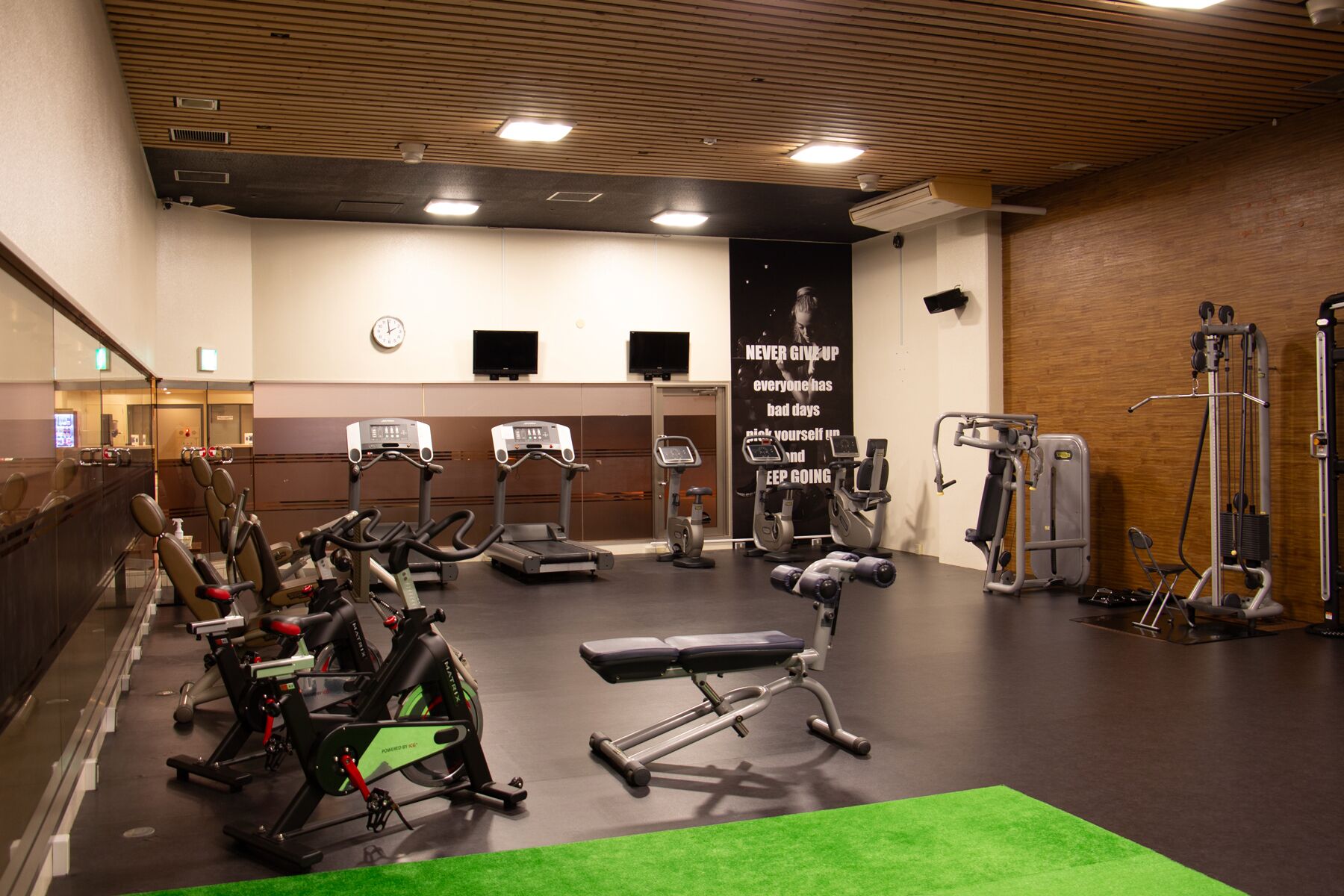 A gym with treadmills, stationary bikes, and weight machines.