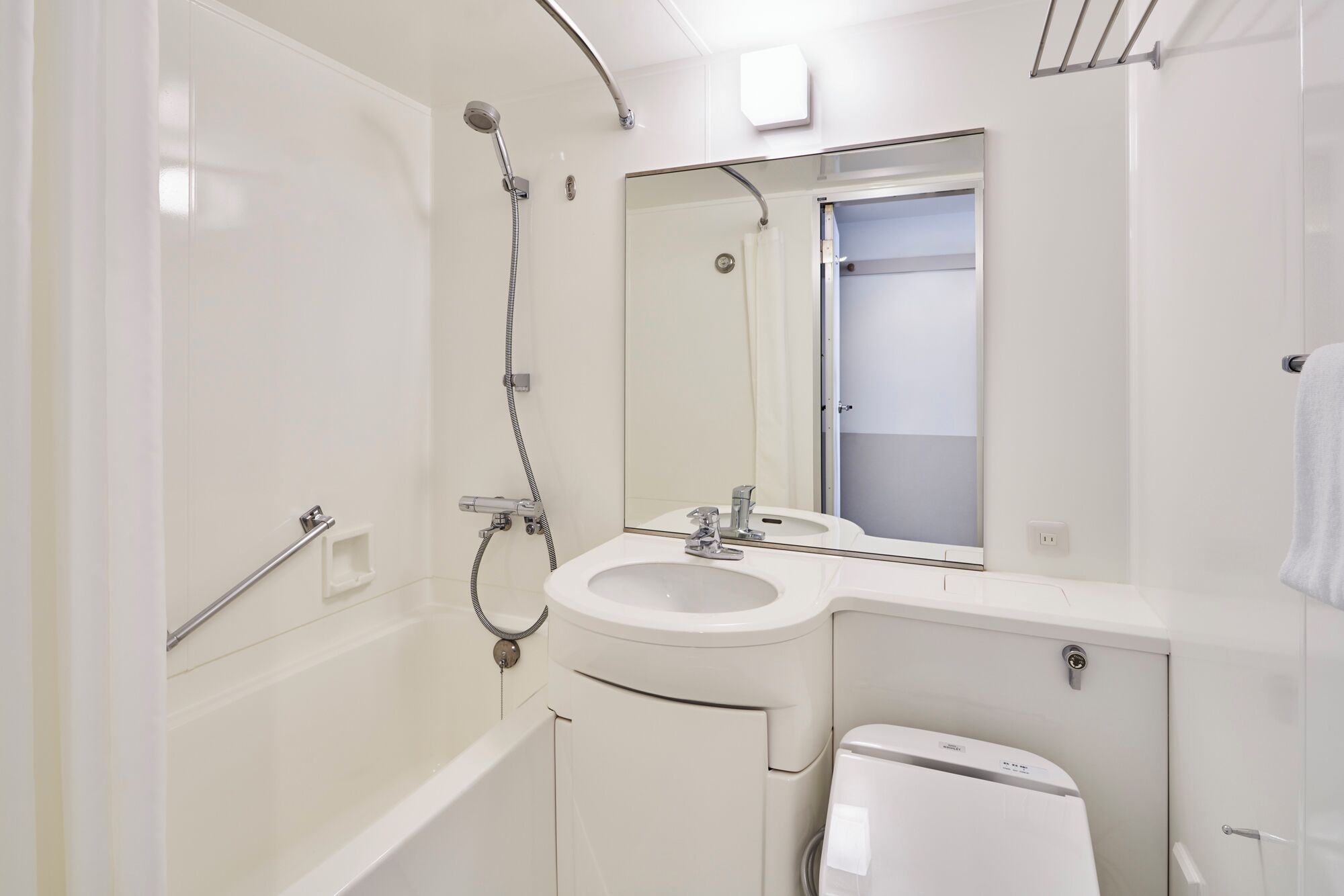 A modern bathroom with a bathtub, a sink, and a toilet.