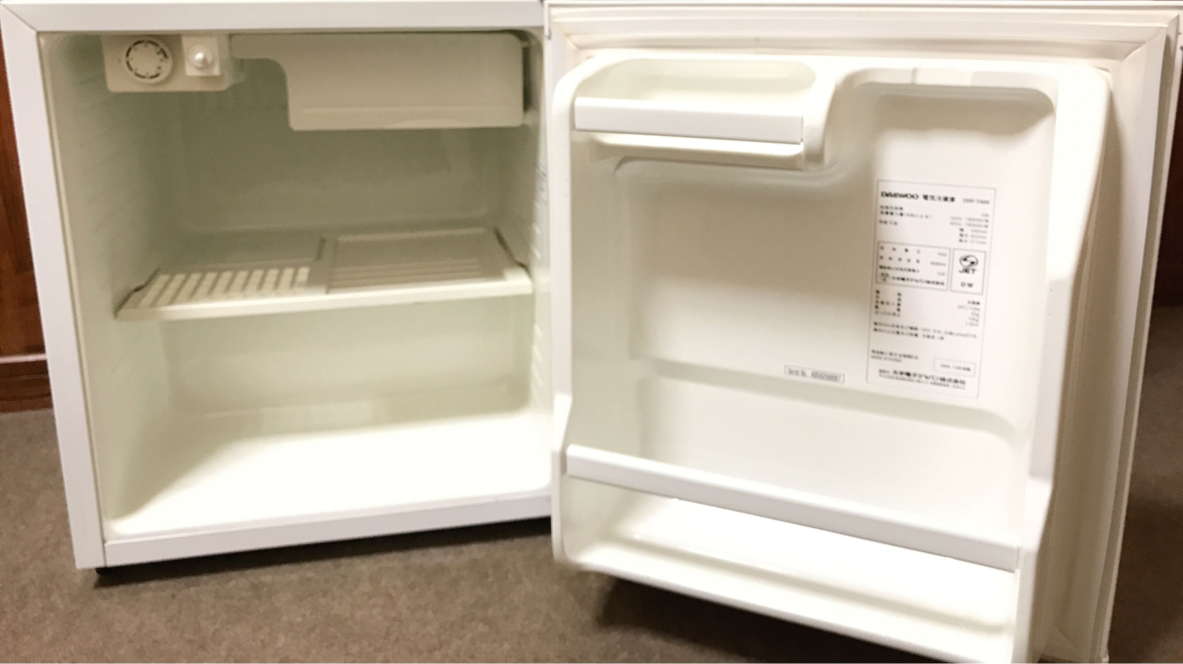An open refrigerator with a control panel on the right side.