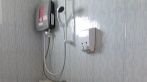 A bathroom with a toilet, a hand dryer, and a paper towel dispenser. - Charm Resort Cha-am (Cha-am)