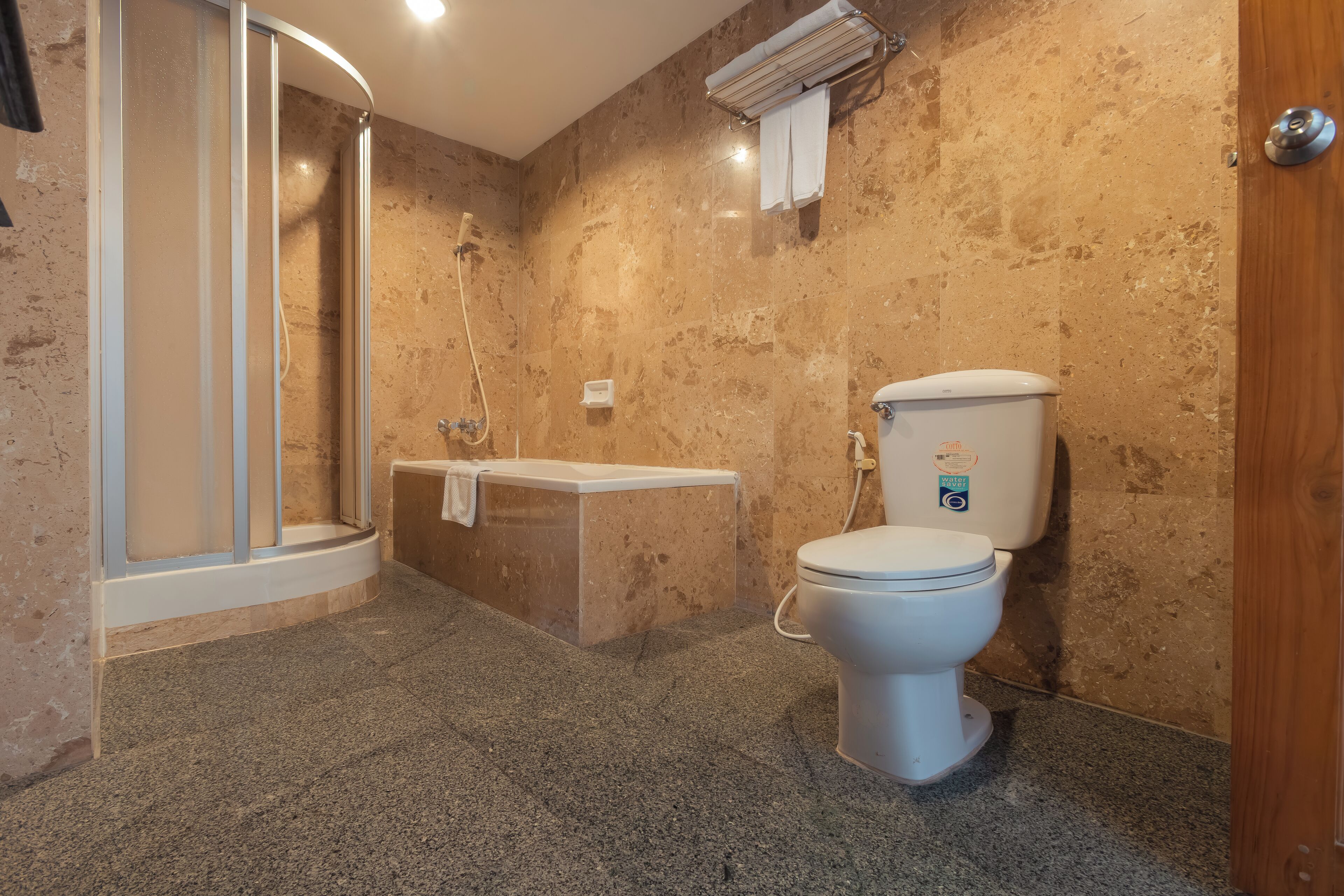 A bathroom with a shower, toilet, and sink.