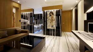 A modern bathroom with a glass-enclosed shower, a large mirror, and a wooden vanity.