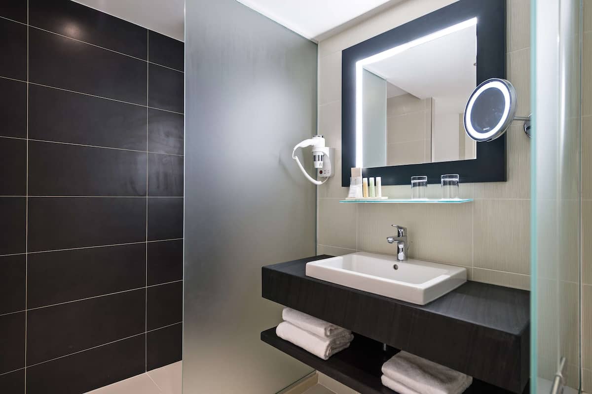 eco-friendly toiletries, hair dryer, slippers, towels