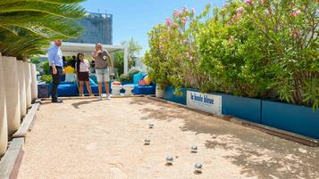 A billiards table in an outdoor area with a blue seating arrangement and a sign reading "la boule bleue".