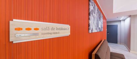 A hotel interior with a sign indicating 'meeting room 2' and a 'in use' label.